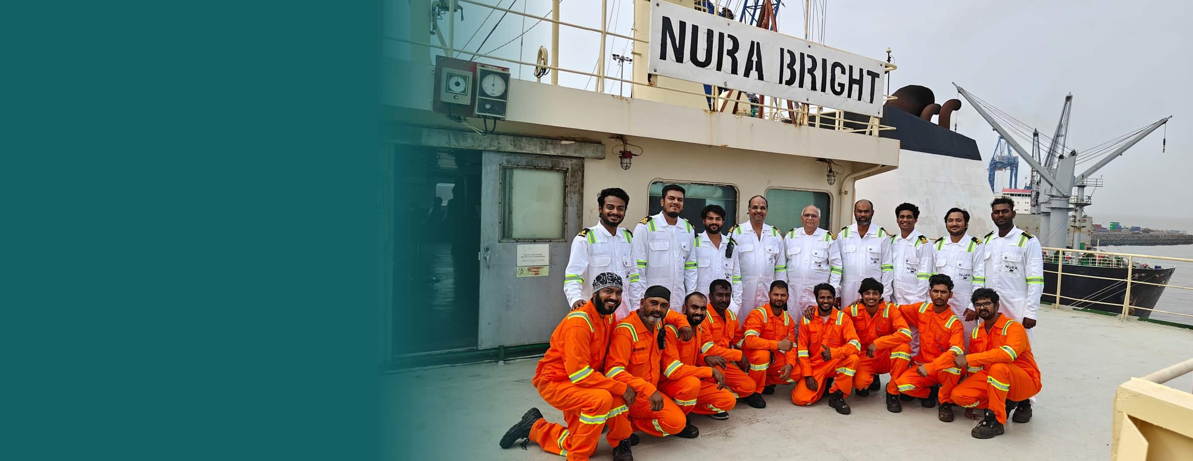 The crew of the NURA Bright in NURA uniforms, gathered on deck in port